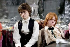 Harry and Ron sitting down at the Yule Ball
