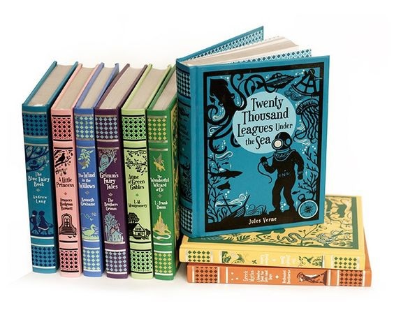 Children's classic books stacked horizonally and veritcally with different colored spines
