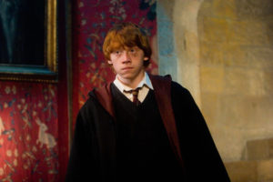 Ron standing in the Gyrffindor Common Room