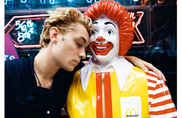 Jude Law shares a touching moment with Ronald McDonald in a photo from the collection of British photographer Rankin.