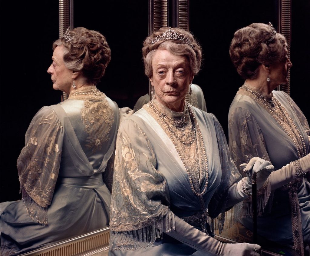 Dame Maggie Smith in character as the Dowager Countess from "Downton Abbey" sits in front of a mirror.