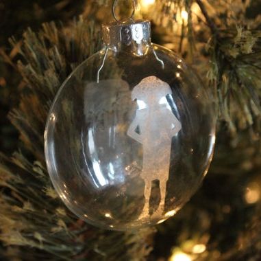 An Etched Glass Ornament with a Silhouette of Dobby. 
