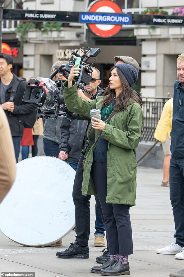 Gemma Chan is seen filming for "The Eternals" in Piccadilly Circus.