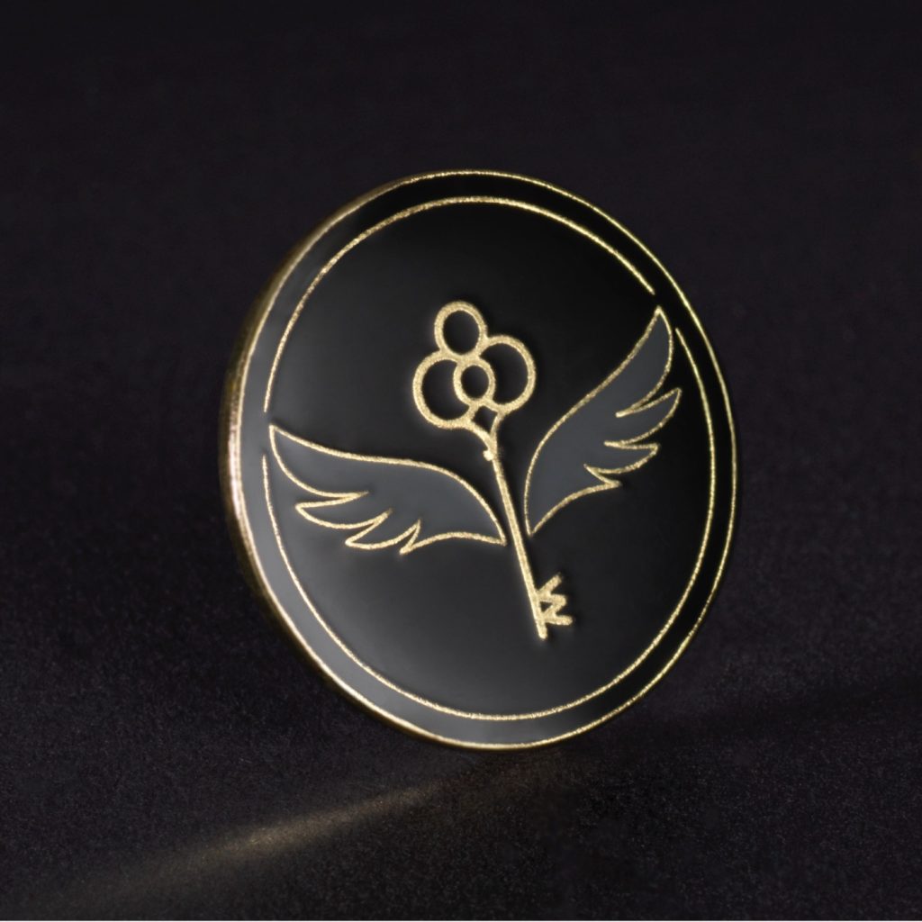 The Gold membership pin features an enchanted key. 