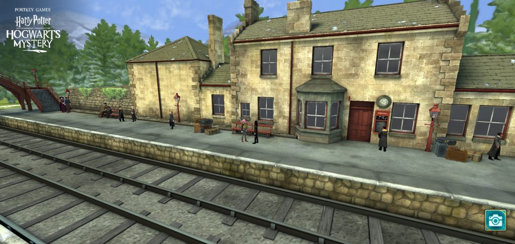 A screenshot from "Harry Potter: Hogwarts Mystery" shows a view of Hogsmeade Station.