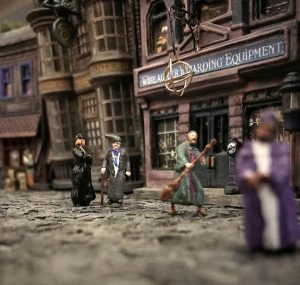 A miniature version of Diagon Alley with figurines walking the streets.
