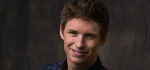 A portrait of Eddie Redmayne looking great against a dark background.