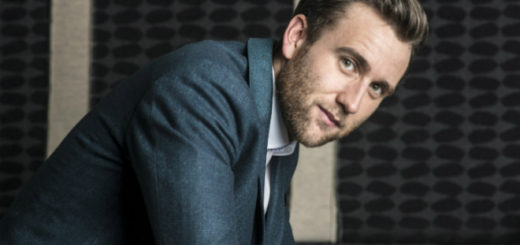 Matthew Lewis is pictured super handsomely in an elegant suit and tie.