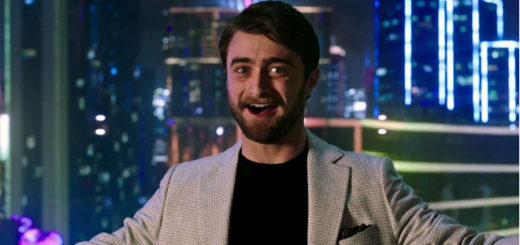 Daniel Radcliffe is tech tycoon Walter Mabry in Now You See Me. He is smiling gleefully and irritatingly at the camera with a big city in the background outside his penthouse's window behind him.