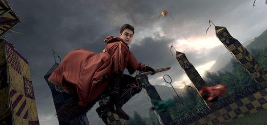 Harry on broom during Quidditch game, looking at camera