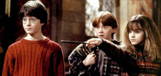 Harry and Ron look on, shocked, as Hermione grimly points her wand at someone off-screen