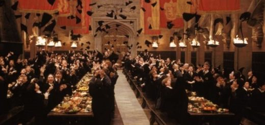 Harry Potter and friends are shown cheering and clapping in the Great Hall at the end-of-year feast.