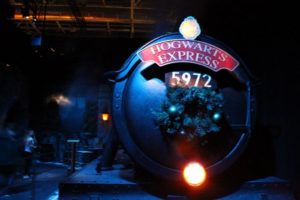 the front of the Hogwarts Express is visible in a dark room