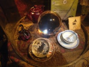 divination class memorabelia including the tea set, the cup with the grim, and a crystal ball