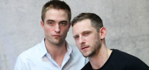 Close-up of Robert Pattinson and Jaime Bell looking serious