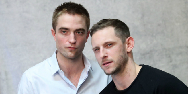 Close-up of Robert Pattinson and Jaime Bell looking serious