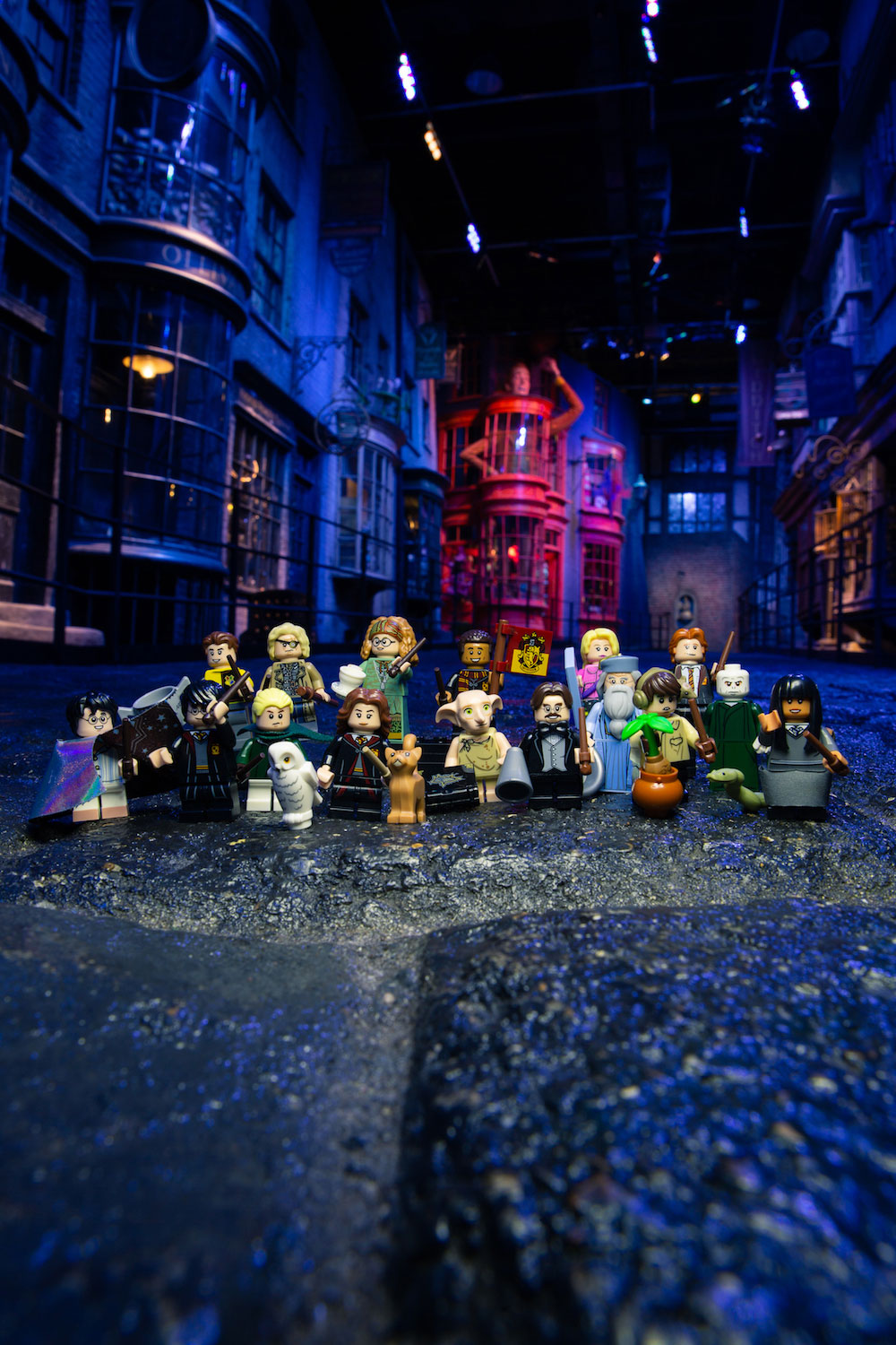 All of the figures included in the “Harry Potter” group of LEGO minifigures pose in front of Diagon Alley at the Studio Tour.