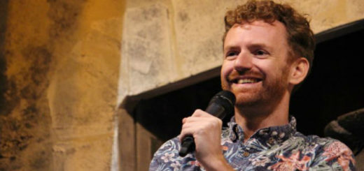 Actor Chris Rankin (Percy Weasley) is photographed holding a microphone in an undated photo.