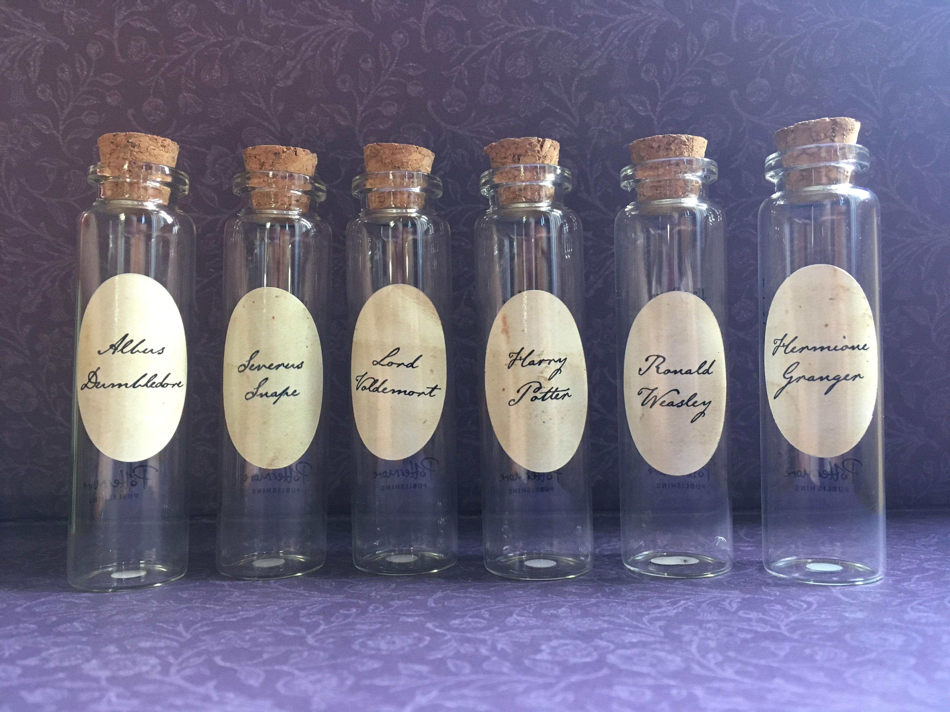 Pensieve vials from Audible’s “A Harry Potter Pensieve Experience,” featuring iconic characters Albus Dumbledore, Severus Snape, Lord Voldemort, Harry Potter, Ronald Weasley, and Hermione Granger