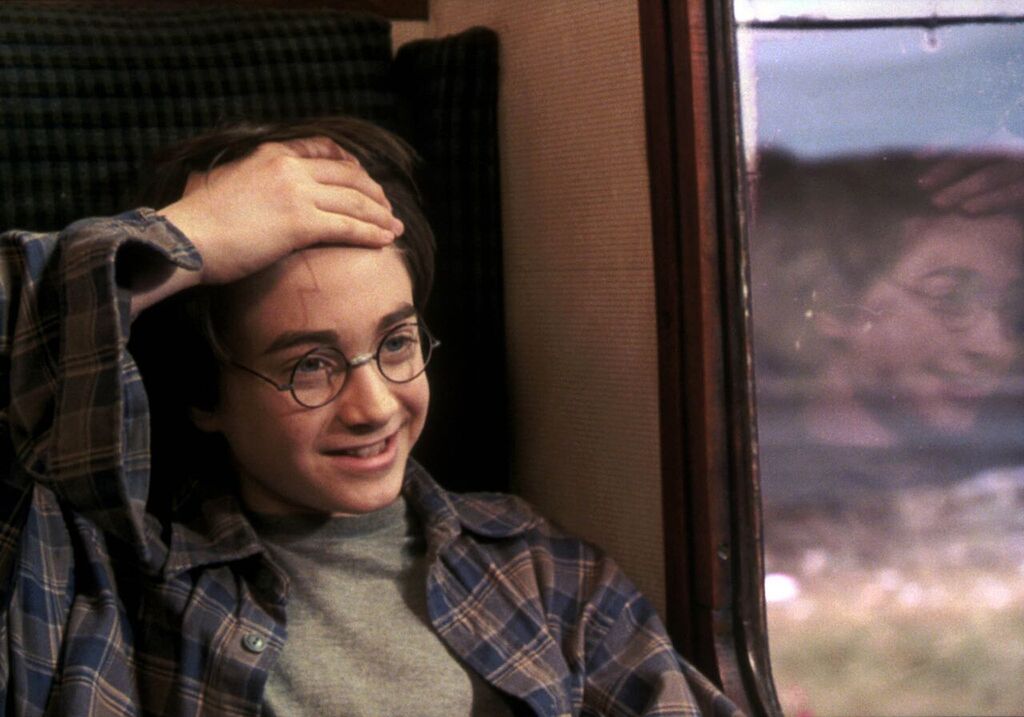 Harry reveals his lightning-bolt scar.