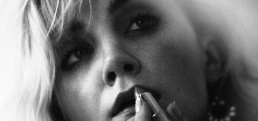 Evanna Lynch applying lipstick in a photo for "PIBE Magazine."