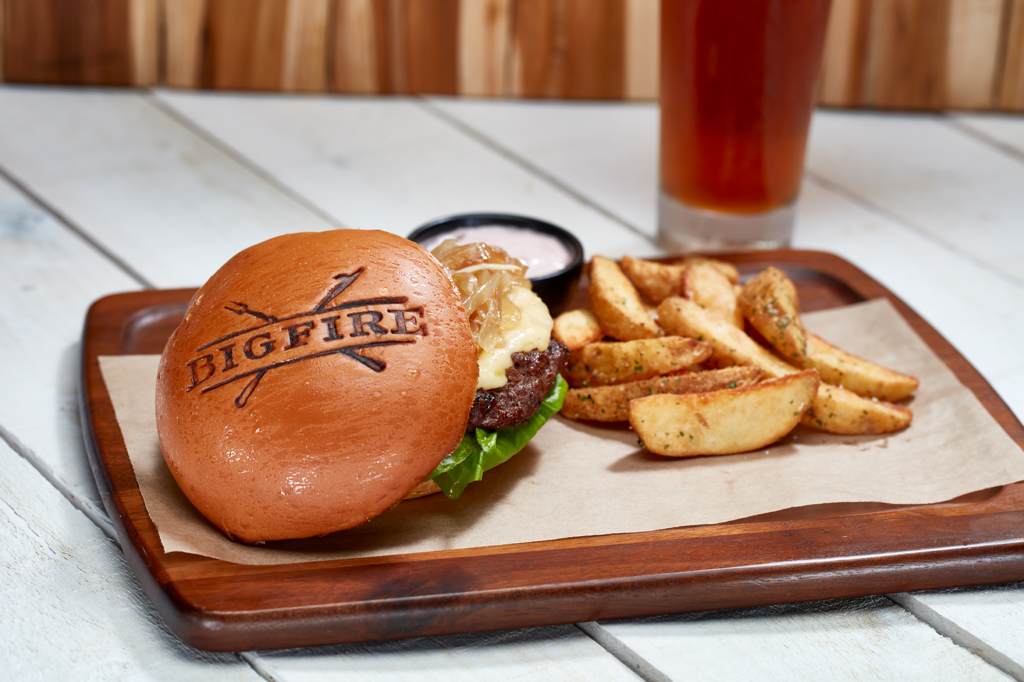 The signature bison burger comes with a side of fries and the restaurant’s logo seared into the bun.