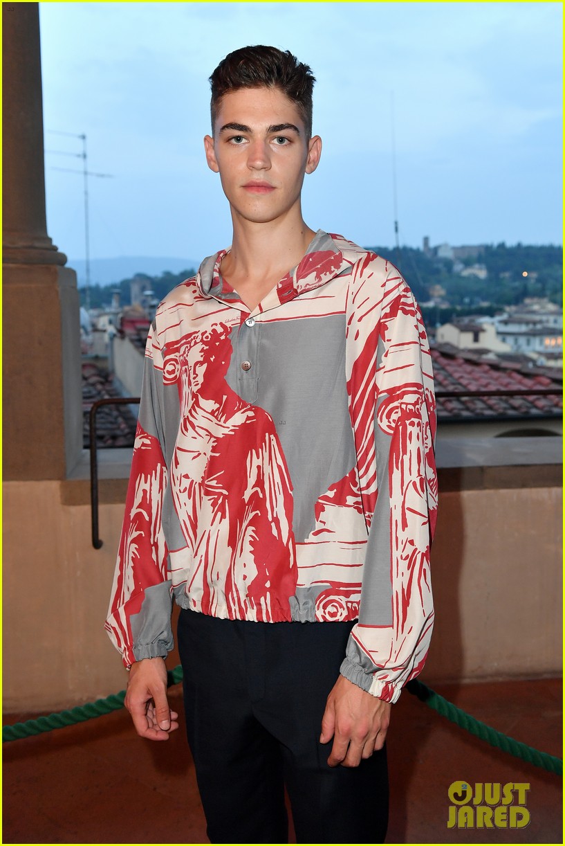Hero Fiennes-Tiffin poses for a photo at a Salvatore Ferragamo fashion show in Florence.