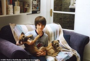 Young Daniel Radcliffe cuddling with his dogs.