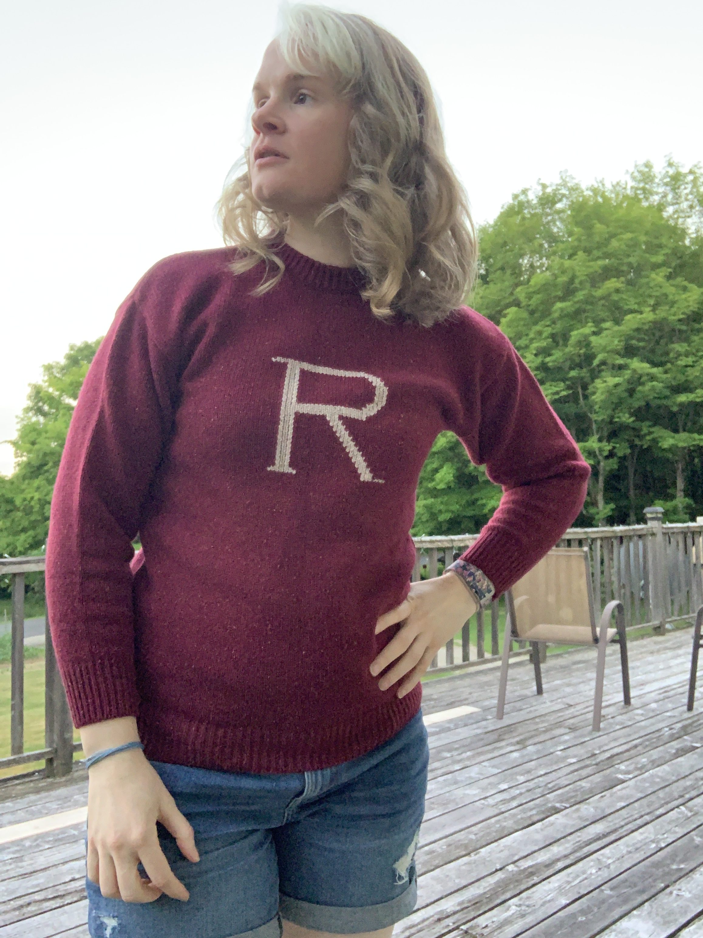 Full frontal view of the maroon “R” sweater being worn