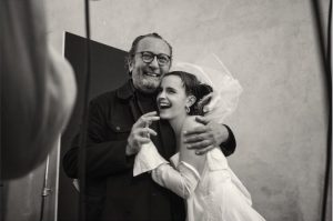 Emma Watson and photographer Paolo Roversi laughing behind the scenes at the Pirelli Calendar 2020 photoshoot.