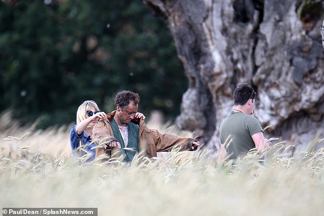 Jude Law dons a jacket during filming for “The Third Day”.