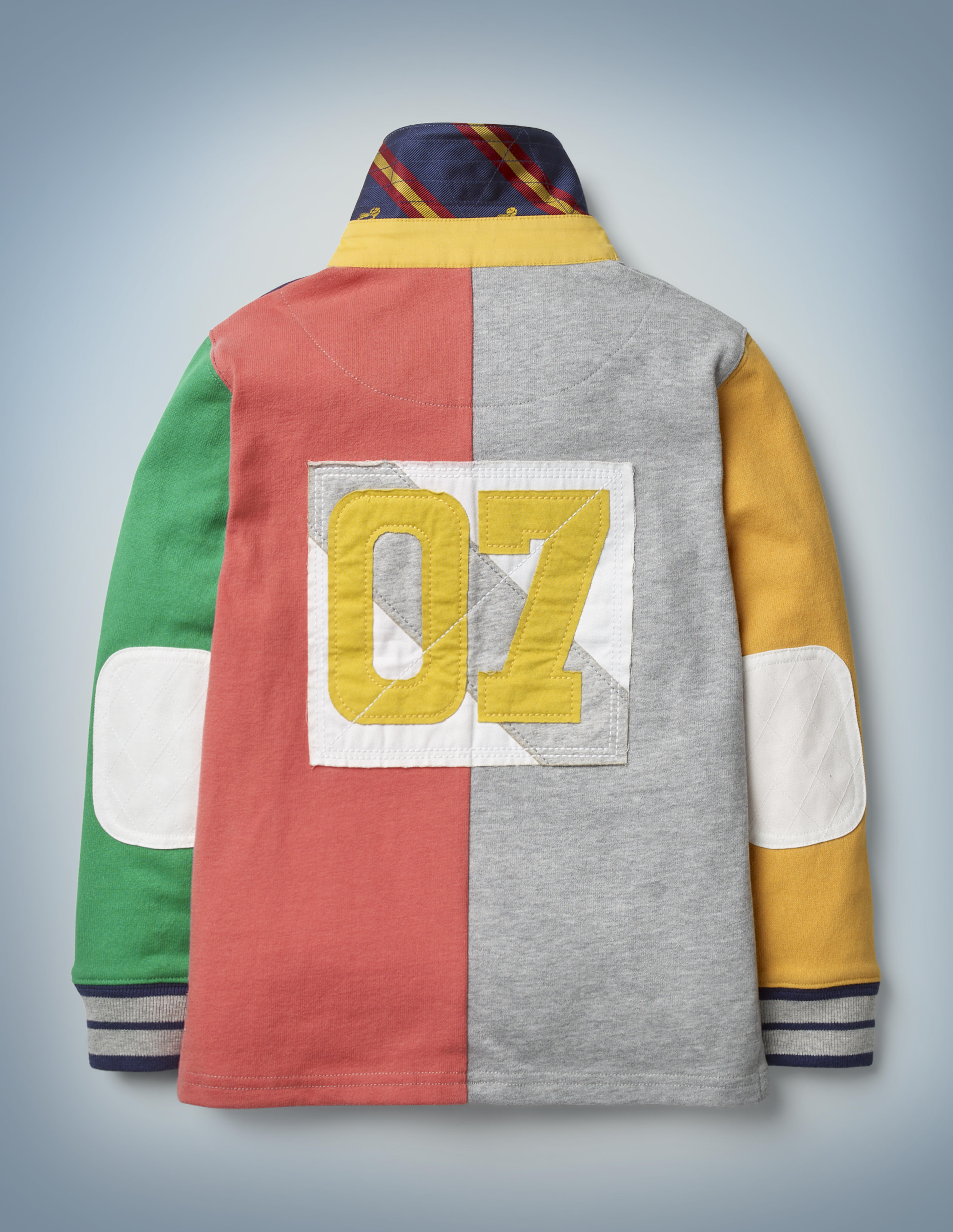 This view of the back of the Mini Boden Hogwarts Rugby Shirt, multi-color, shows a patch featuring Harry Potter’s Quidditch number: 07. It retails at £30.