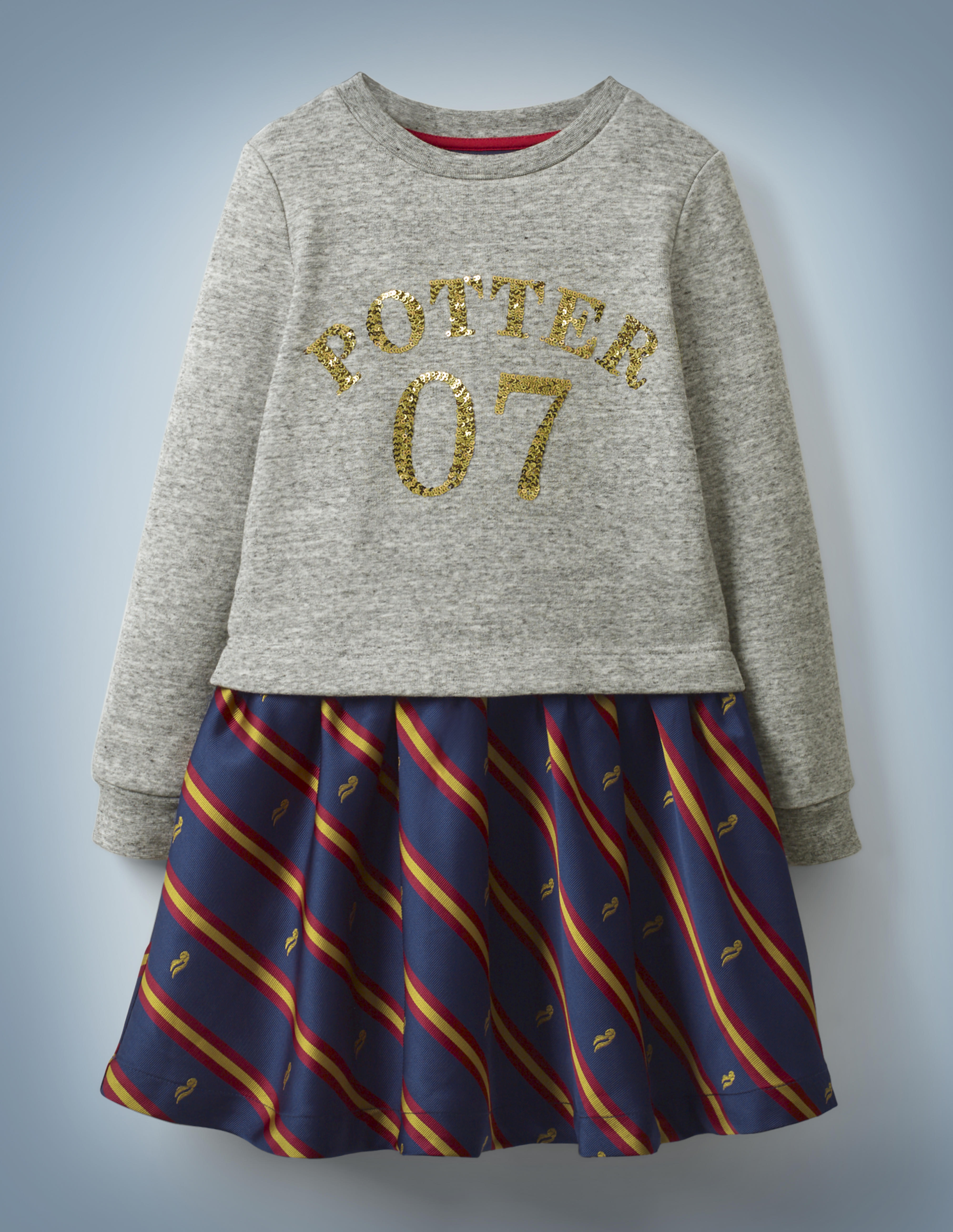 The Mini Boden Sequin Seeker Dress resembles a skirt and top and features a heather gray, long-sleeved top with gold sequins reading “Potter 07” and blue skirt bottom with red-and-gold stripes and Golden Snitches. It retails at £35.