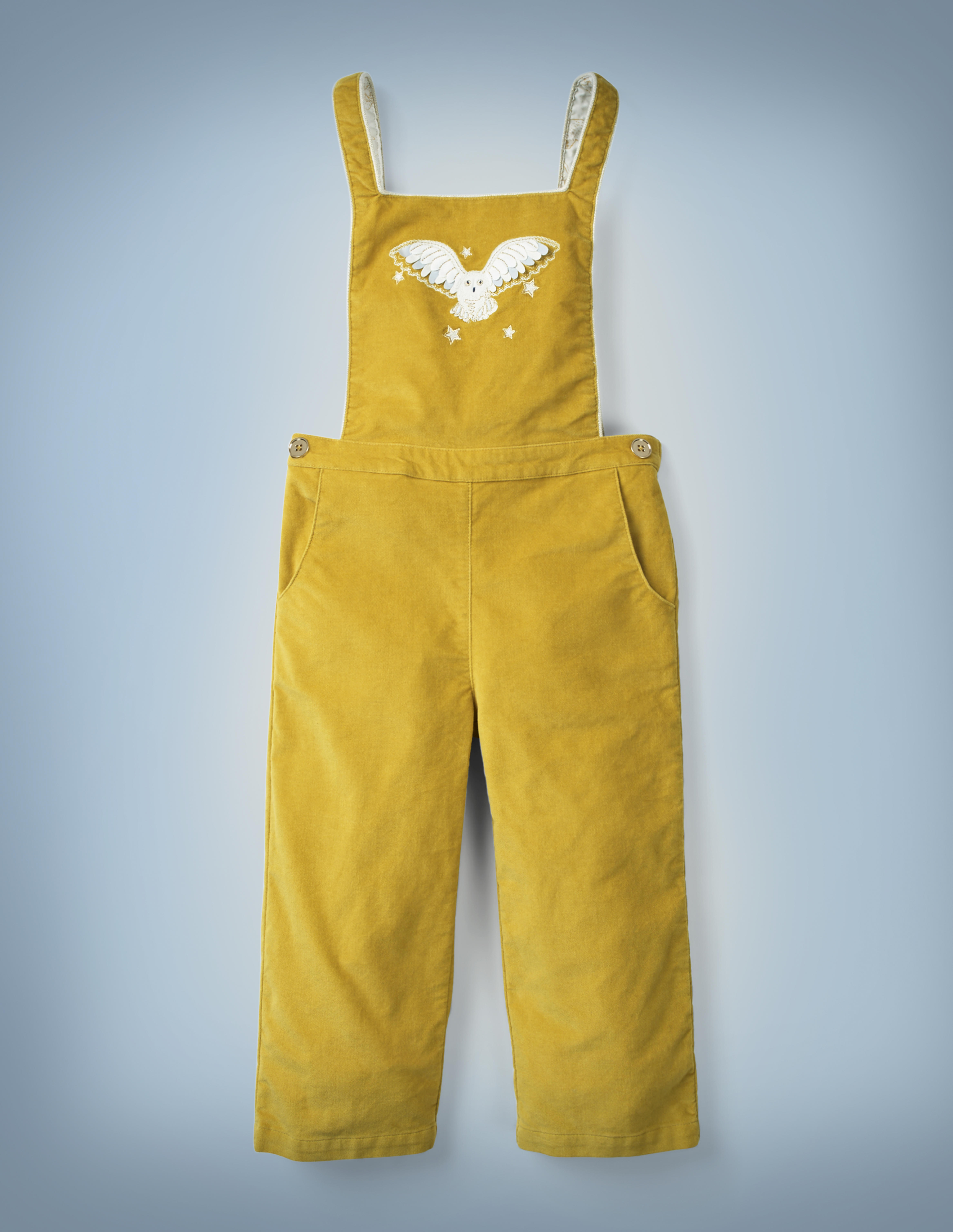 The Mini Boden Hedwig Dungarees in mustard yellow feature a design of Harry Potter’s beloved owl flying through the stars on the breast of the overalls. They retail at £40.