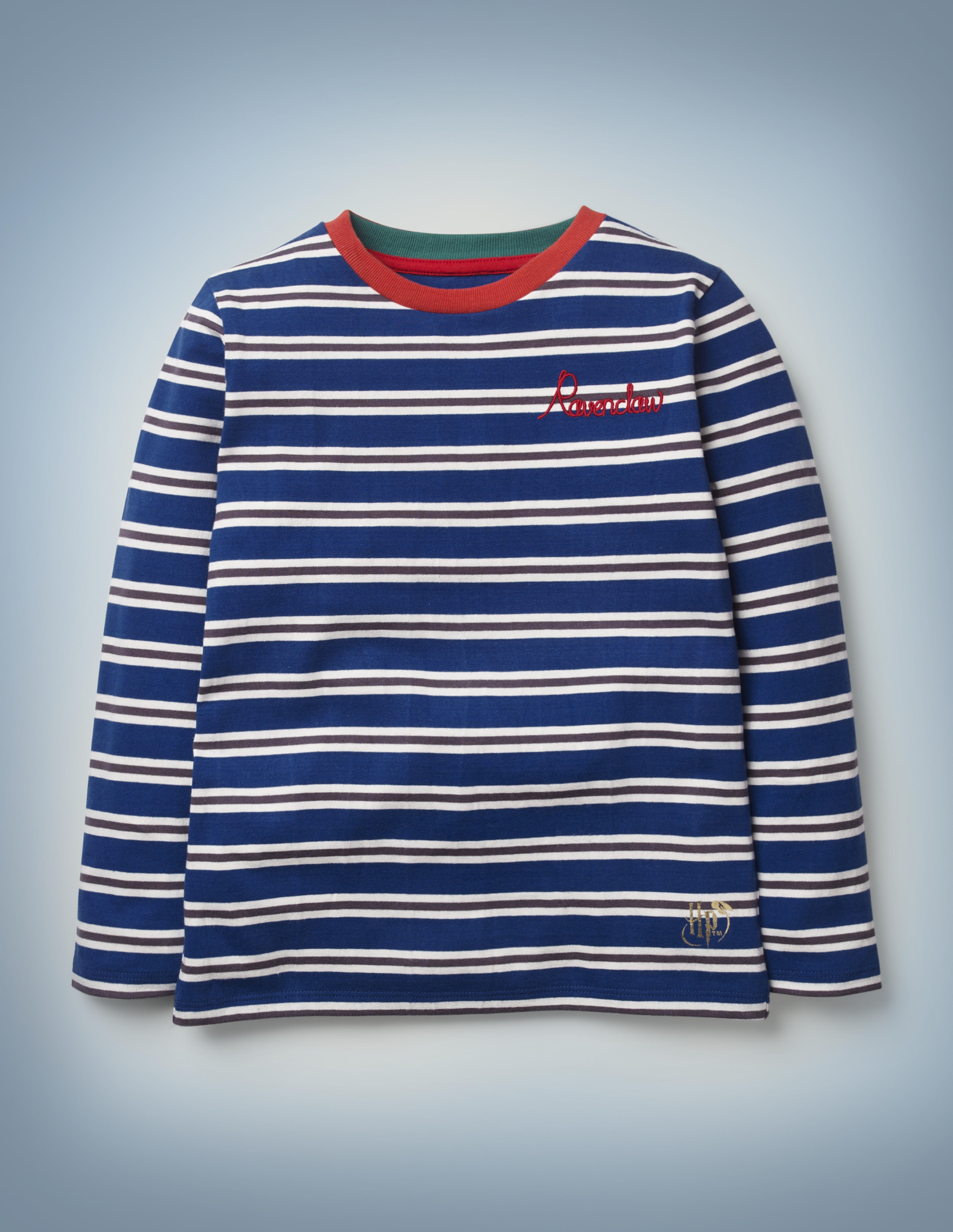 The Mini Boden House Breton in blue features all-over blue and silver stripes, a red collar, and “Ravenclaw” written in red script in the front pocket area. It retails between £20 and £22.