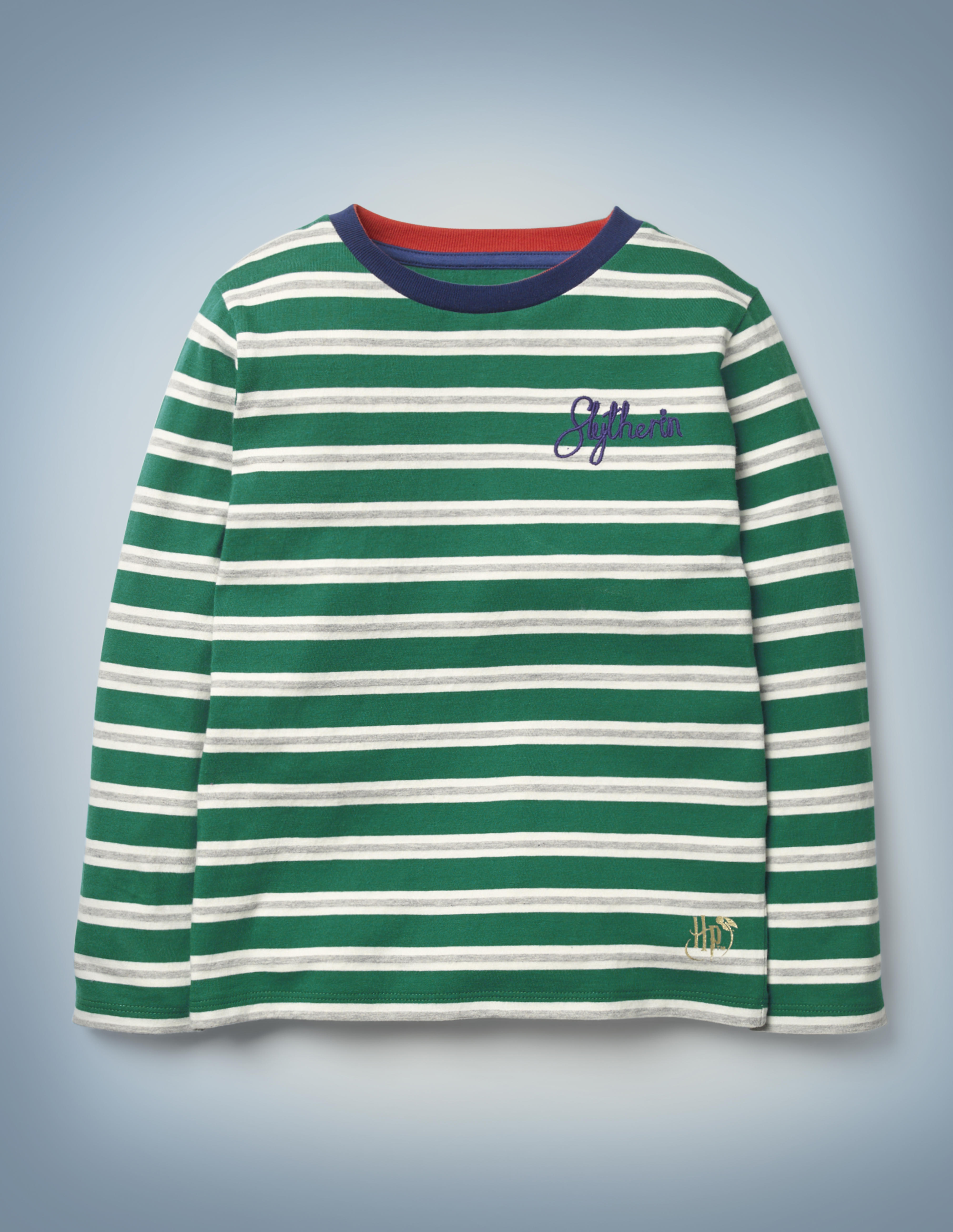 The Mini Boden House Breton in green features all-over green and silver stripes, a blue collar, and “Slytherin” written in blue script in the front pocket area. It retails between £20 and £22.