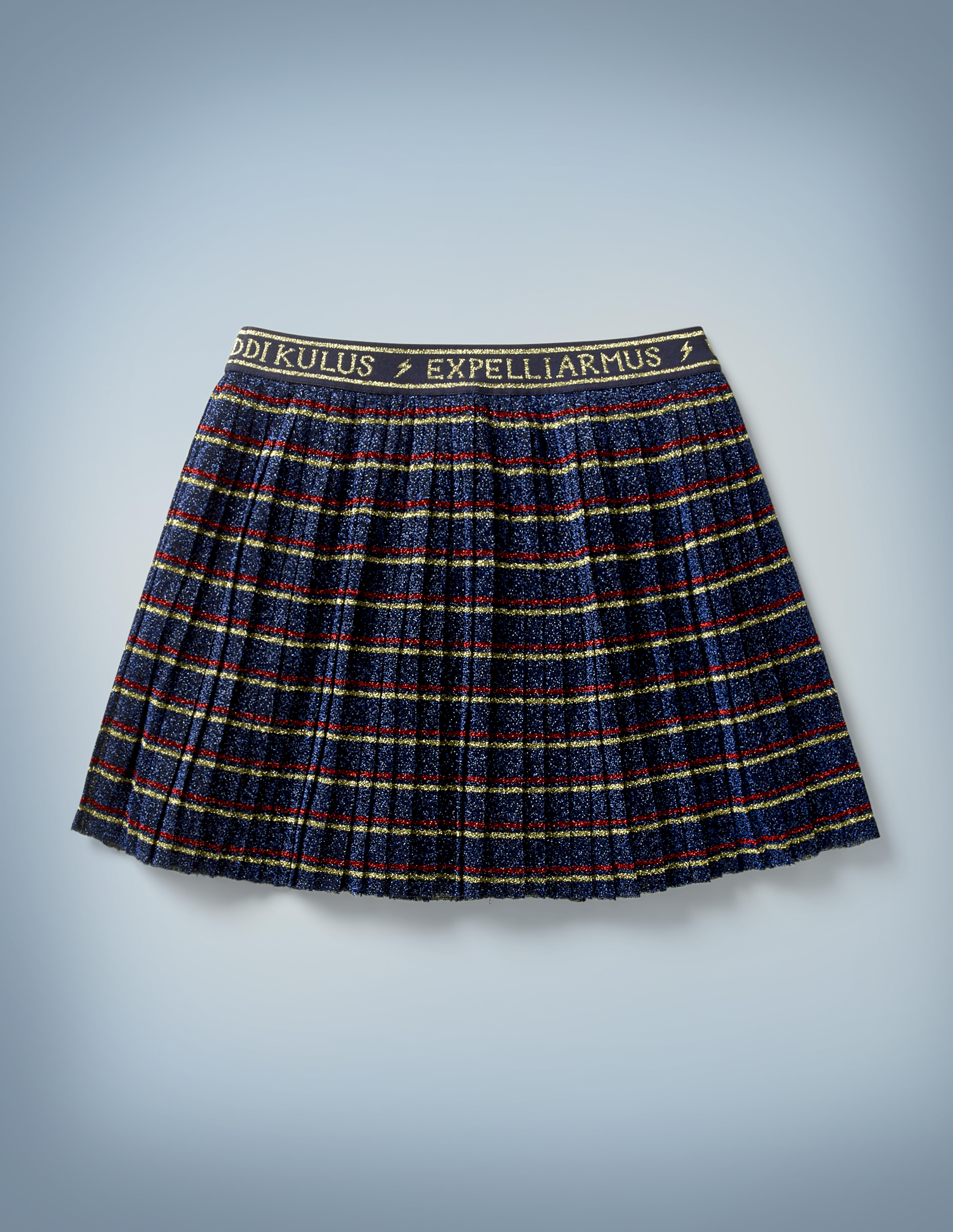 The Mini Boden Spell Skirt is navy blue with red-and-gold stripes and a waistband that features spell incantations such as “Riddikulus” and “Expelliarmus” written in gold and separated by lightning bolts. It retails at £30.