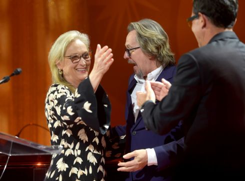 Gary Oldman and Antonio Banderas greet Meryl Streep after presenting her with a Tribute Award during the Toronto International Film Festival.