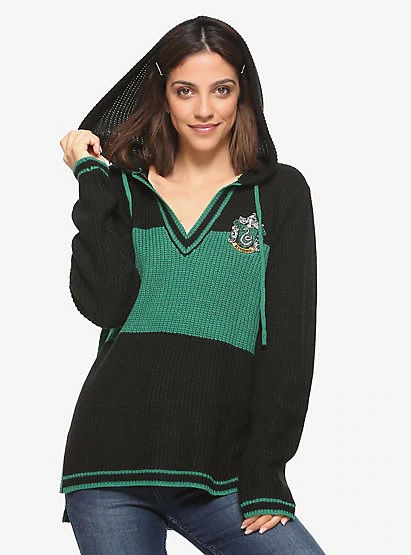 A model shows off the drawstring hood on her Slytherin sweater from Hot Topic.