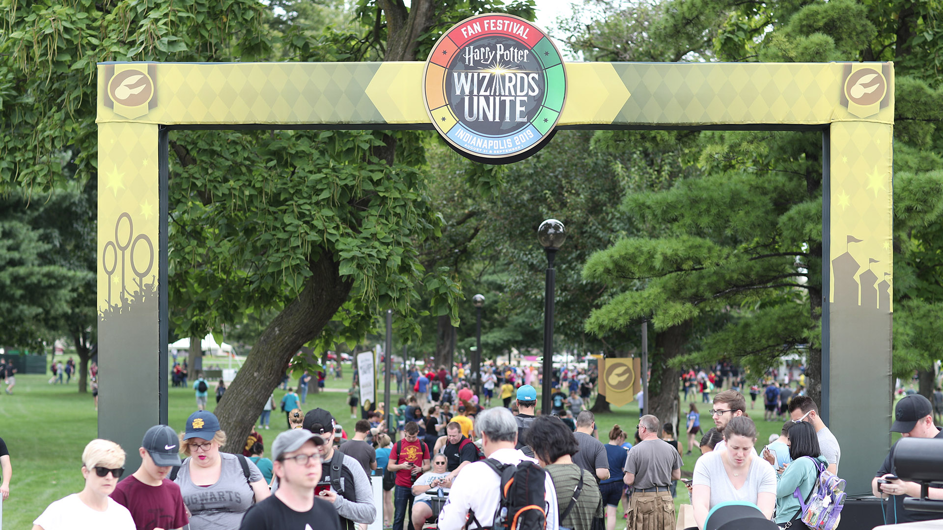Attendees of the “Harry Potter: Wizards Unite” Fan Festival make their way beneath an archway at White River State Park.