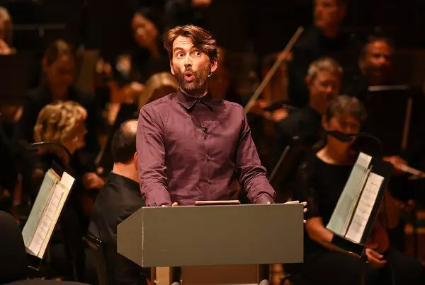 David Tennant puts on a shocked face during a reading from “Good Omens”.