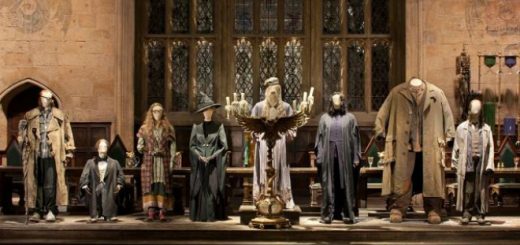 Figures of the Hogwarts staff standing at the front of the Great Hall