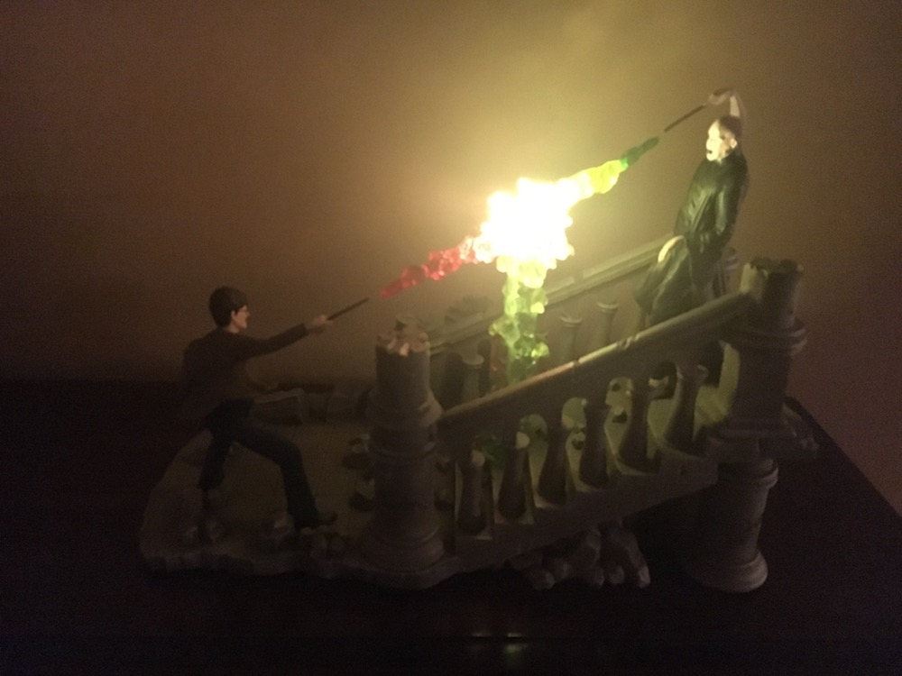 Back view of Battle of Hogwarts Illuminated Sculpture by The Bradford Exchange lit up