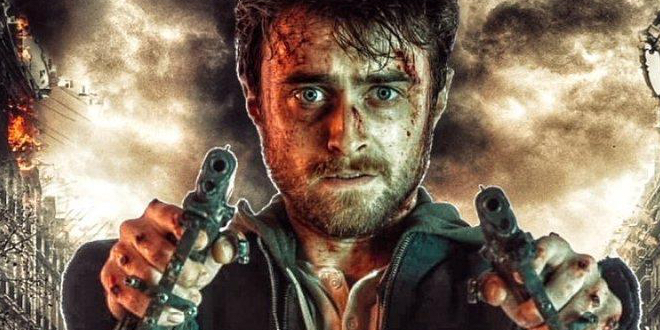 Daniel Radcliffe holds two guns at the camera with a stormy background behind him.