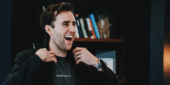 Matthew Lewis is super smily and laughing.