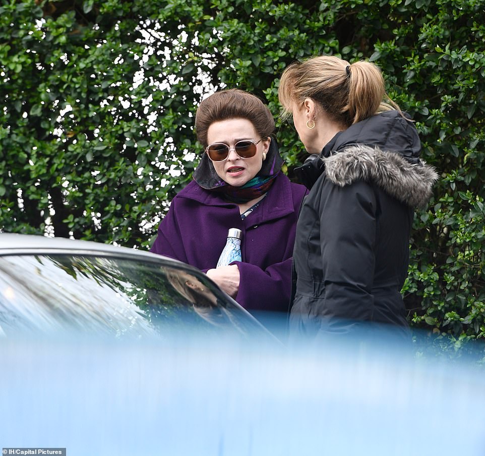 Helena Bonham Carter talks with a crew member during filming for Season 4 of “The Crown”.