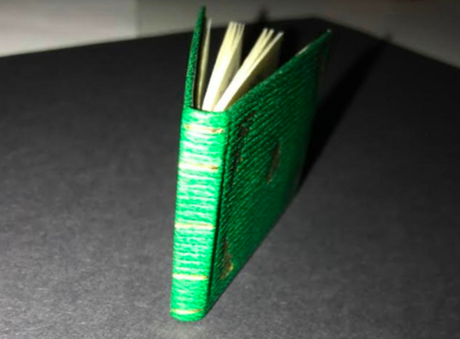 The book has a green-and-gold hard cover.