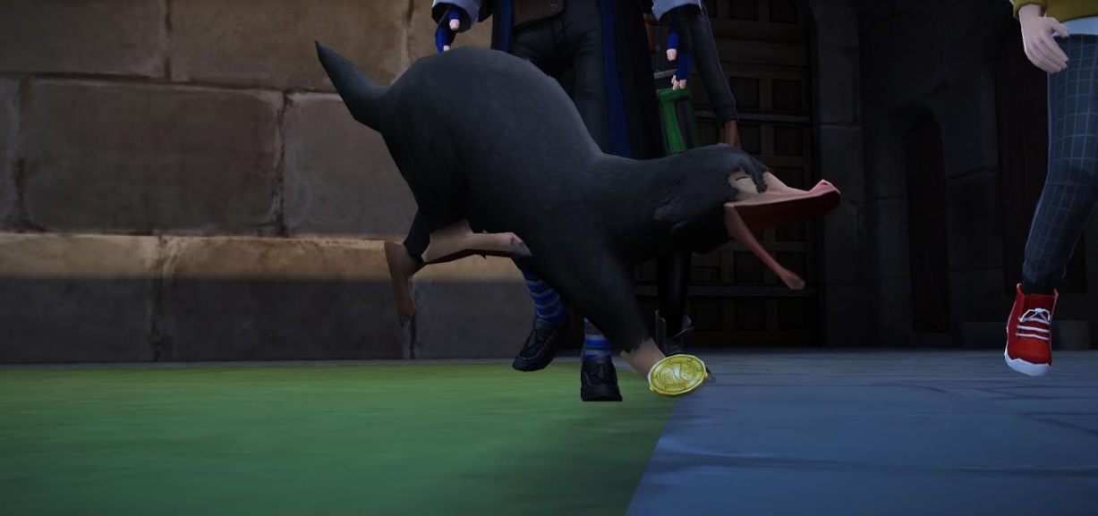 A Niffler leaps after a gold coin in "Harry Potter: Hogwarts Mystery".