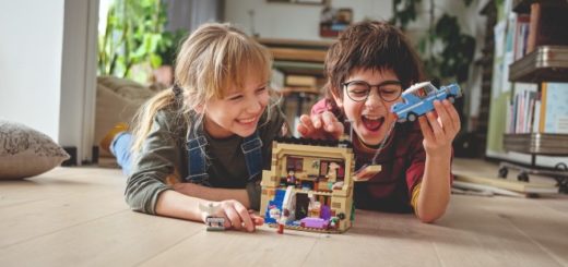 Two children are shown playing with a LEGO "Harry Potter" Privet Drive set.