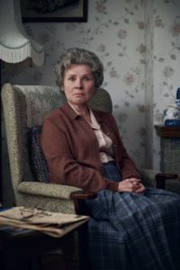 Imelda Staunton as the Lady of Letters in Alan Bennett's Talking Heads. She is sitting in an armchair in an average living room.